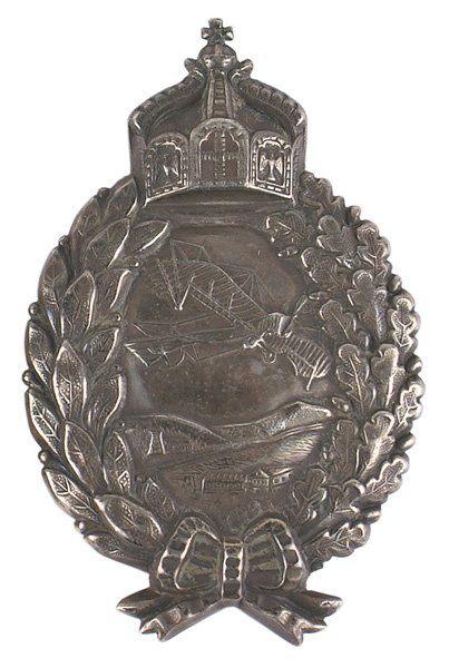 Imperial German Prussian Pilot Badge: S-019 Imperial German Prussian Pilot's Badge with a screwback/rayback, with screwback plate present, and a full set of "C.E. JUNCKER-BERLIN" hallmarks plus moon, crown and "800" silver. Nice patina. I