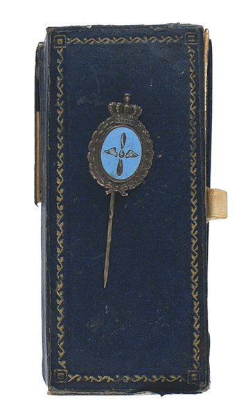 Bavarian Pilot Badge stick pin: S-068 Imperial German Bavarian pilot's stick pin. Age darkened silver crowned oak leaf wreath is holding a blue enameled oval center with an age darkened etched wing prop. Reverse is maker marked "L. 