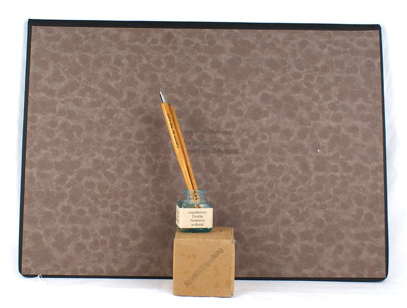 German WWII Army desk set: H-076 Third Reich Army desk set. Includes: (1) 13 3/4" x 19" blotter with a folding hard stock board. Marked "Eigentum der Wehrmacht...". (2) Ceramic ink well. Base is marked with an eagle/swastika. W