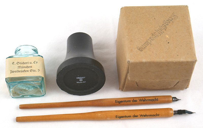 German WWII Army desk set: H-077 Third Reich Army desk set. Includes: (1) Ceramic ink well. Base is marked with an eagle/swastika. With original cardboard box. (2) Glass ink well. Original paper label with an eagle/swastika, ma