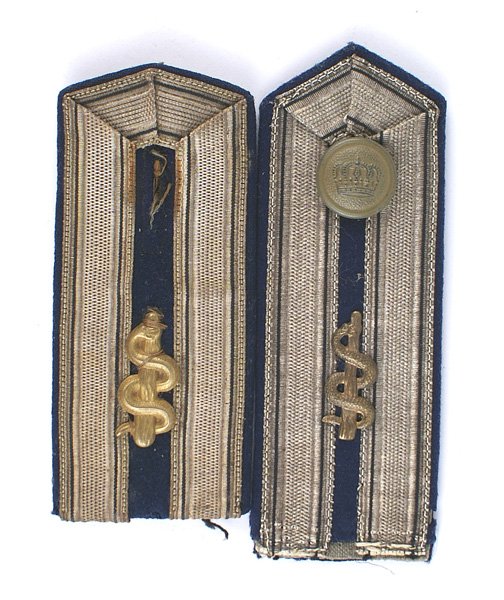 Imperial German Prussian Medical shoulder boards: H-093 Lot of 2 single Imperial German Prussian Medical Officer shoulder boards. Age toned gilt staff/serpent insignia affixed to a pointed blue shoulder board with an inner border of wide flat silver 