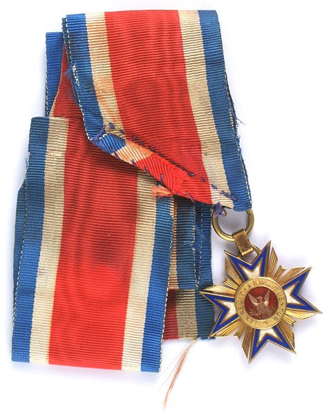 The Military Order of the Loyal Legion medal: K-046 The Military Order of the Loyal Legion of the United States. Blue and white enameled cross with gold frame/rays/eagle in center on red enamel. (MOLLUS). Numbered "6715". With pin bar and origina