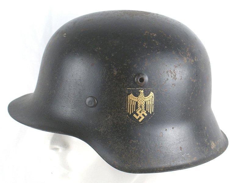 German WWII Navy M1942 helmet: E-029 German WWII Navy M1942 black finished helmet. Shows some expected wear. Original gold eagle/swastika decal is 98% intact. Stained/darkened leather liner shows wear. With chinstrap. II