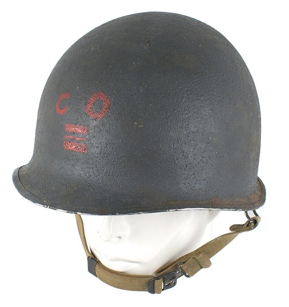 U.S. Army WWII helmet: E-049 U.S. Army WWII helmet. Green sand finish, swivel bale type with a "split" front seam. A red "CO" above horizontal lieutenant bars are painted on the front of the helmet. Web chinstrap. With a fi