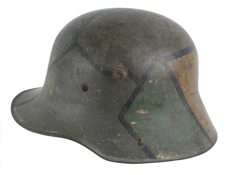 German M1916 camouflage helmet: E-062 German M1916 camouflage helmet. Stained glass pattern green mustard and lighter green with black lined divisions. Has never been cleaned. Missing liner/band and chinstrap. II