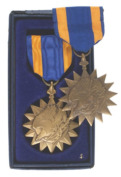 Lot of 2 U.S. WWII Air Medals: B-272 Lot of two U.S. Air Medals. Both with a crimp brooch. (1) WWII. Script engraved "Cpl. Lawrence M. Miller". (2) In a fitted box which is dated "A-1/67". Made by "HIS LORDSHIP INC". II+