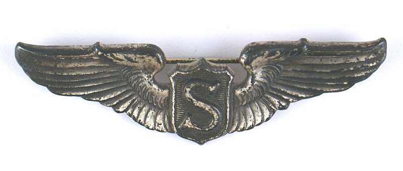 Service Pilot U.S. WWII wings: B-374 U.S. Service Pilot WWII wings. Silver. Winged shield panel bearing a high relief "S". 40% of the applied darkened finish remains. Recessed reverse center is marked "STERLING". Horizontal pin. II