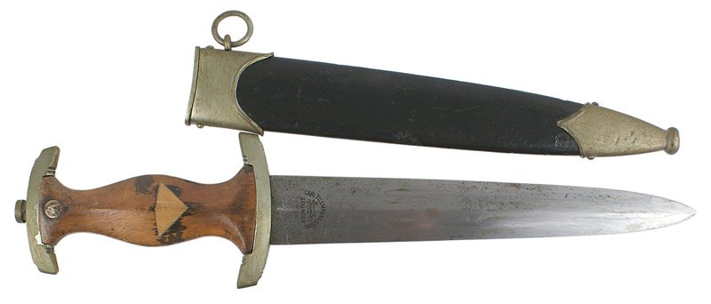 German WWII NSKK EM dagger: D-003 German WWII NSKK EM dagger. Eagle insignia was removed from grip and was replaced with an inverted wood triangle. Crossguard marked "S". Gray blade had the motto removed. Reverse still bears a r
