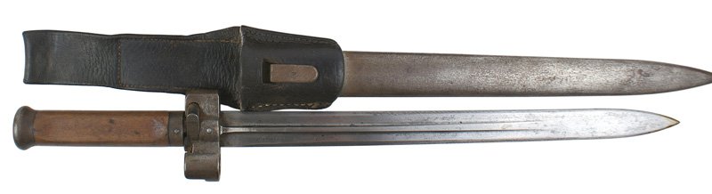 Hungarian M1935 Mannlicher bayonet: D-059 Hungarian M1935 Mannlicher bayonet. Round flat top steel pommel. Circular opening in top. One-piece wood grip. Short steel crossguard/muzzle ring/press locking bar. 13 1/4" double-edged steel bl