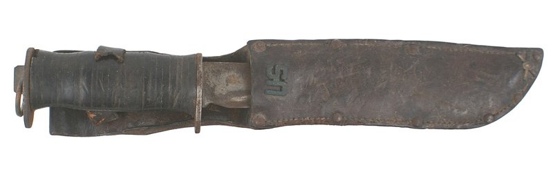 U.S. WWII combat knife WATERMAN: D-069 U.S. WWII combat knife - made by the E.G WATERMAN & CO of New York City. 7 3/8" blade has darkened and shows wear. Flat pommel with a steel ring. Leather rings grip. Leather scabbard has name of