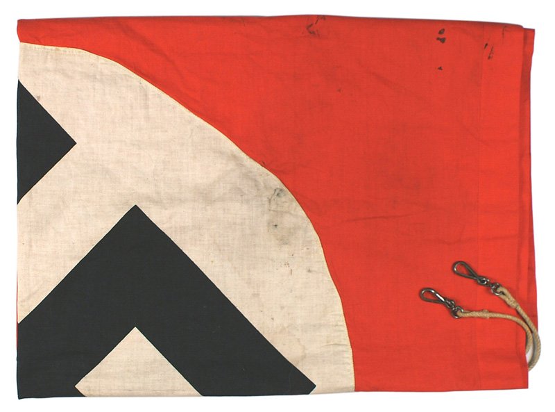 German WWII NSDAP flag: H-102 German WWII NSDAP flag. Large printed black swastika on white disc center, sewn to a red field. Original rope in sleeve-with snap hooks. 46" x 65". Soiled. II-