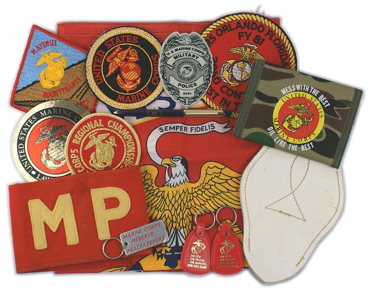 Lot of USMC post war items Marines: H-163 Lot of USMC post war items: (1) Decorative table cover. Large EGA within a ribbon frame with "UNITED STATES MARINE CORPS". 21 1/2" x 22 1/2". (2) "MP" armband. Yellow-gold felt lettering on a re