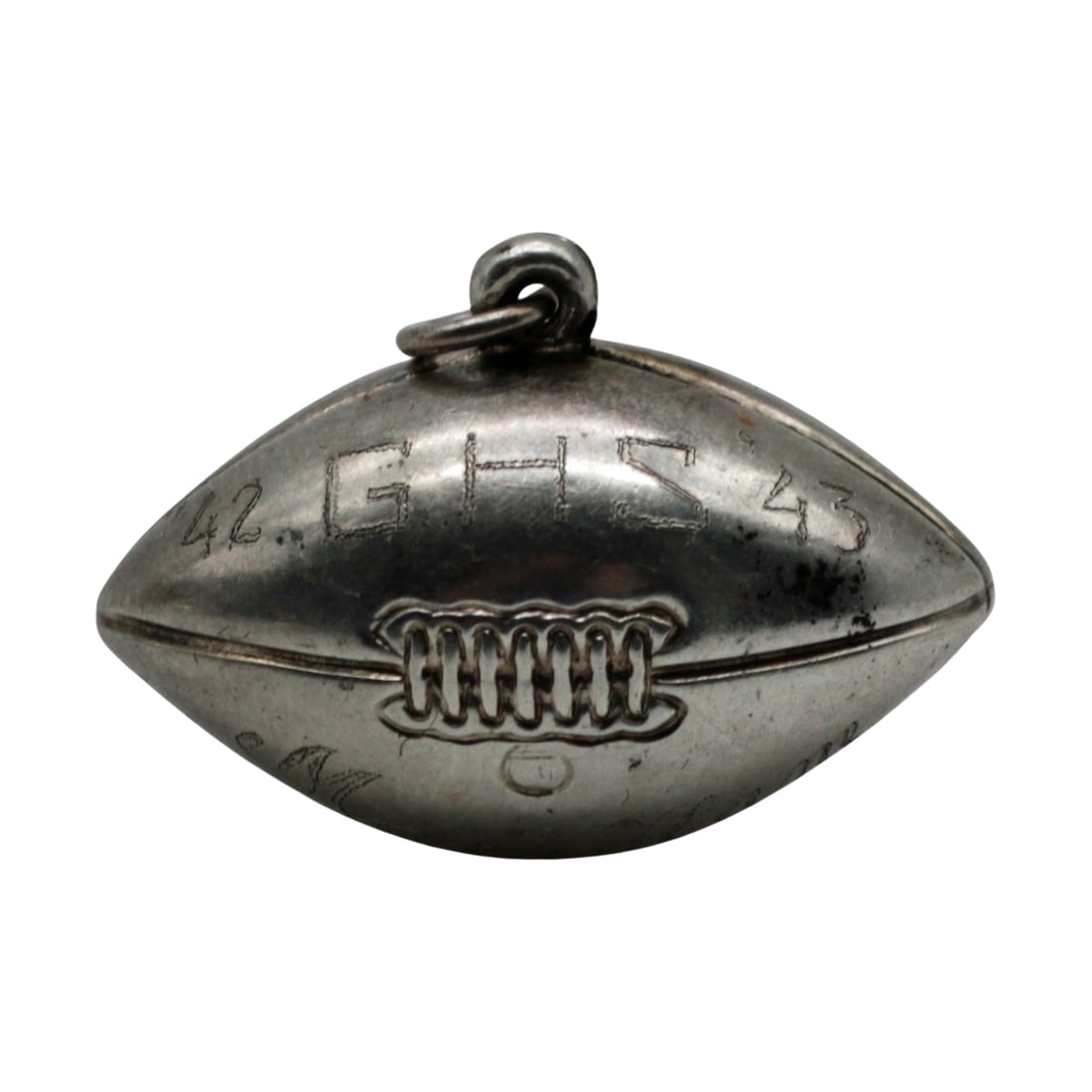 Sterling Silver 1942-43 GHS Football Pendant - Mark Ham III Provenance: Summary Sterling silver football form pendant engraved Mark Ham / 42 GHS 43 / Left End, stamped STERLING. This athletic charm commemorates the 1942 regional championship season of Gainesville High Sch