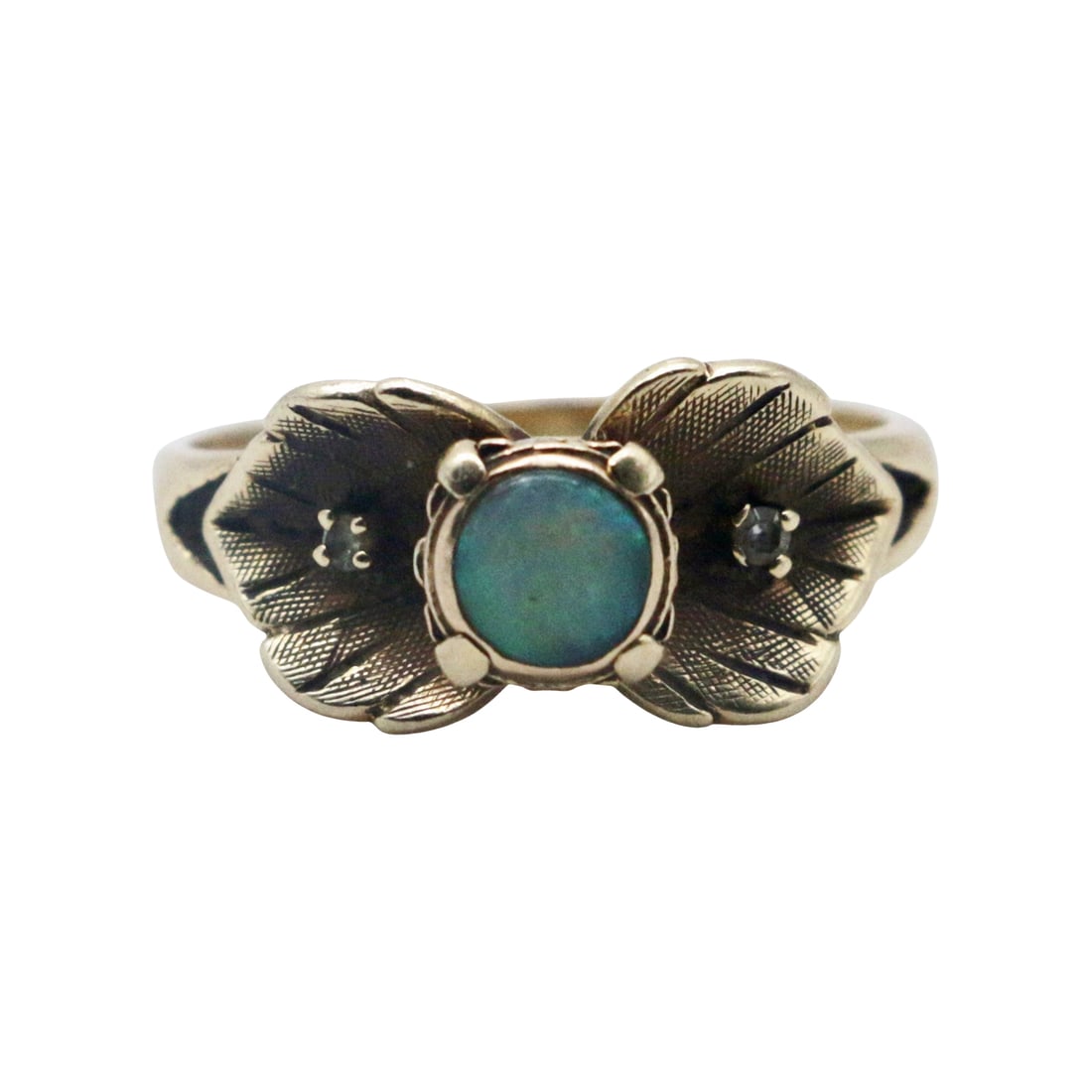 Vintage 14K Gold Opal and Diamond Leaf Ring - Size 7 1/4: Summary Vintage 14K yellow gold ring featuring a central round opal cabochon flanked by two small white accent stones, set within engraved leaf and ribbon shoulders. The design presents a balanced bot