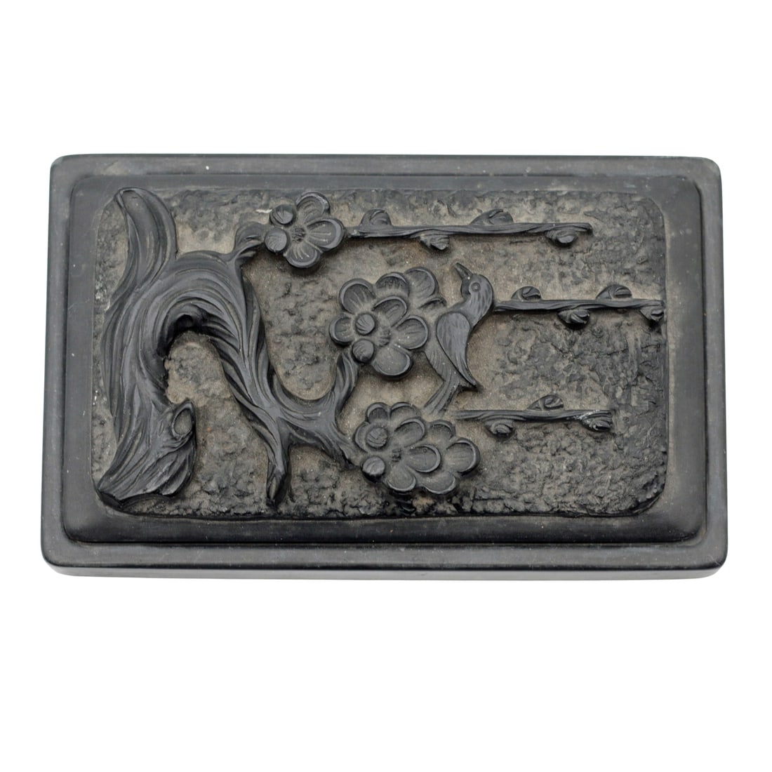 Chinese Inkstone with Carved Bird and Plum Blossoms: Identification Chinese carved inkstone in dark stone, rectangular form with fitted lid, featuring a bird perched among flowering plum branches and gnarled tree in high relief over a textured ground. T