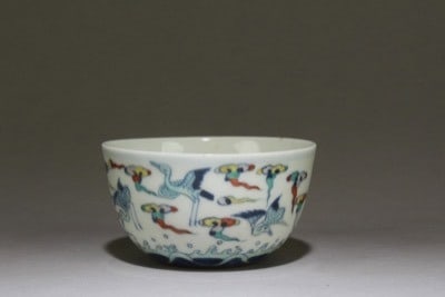 A Chinese porcelain doucai crane and cloud bowl, bearing a Chenghua mark