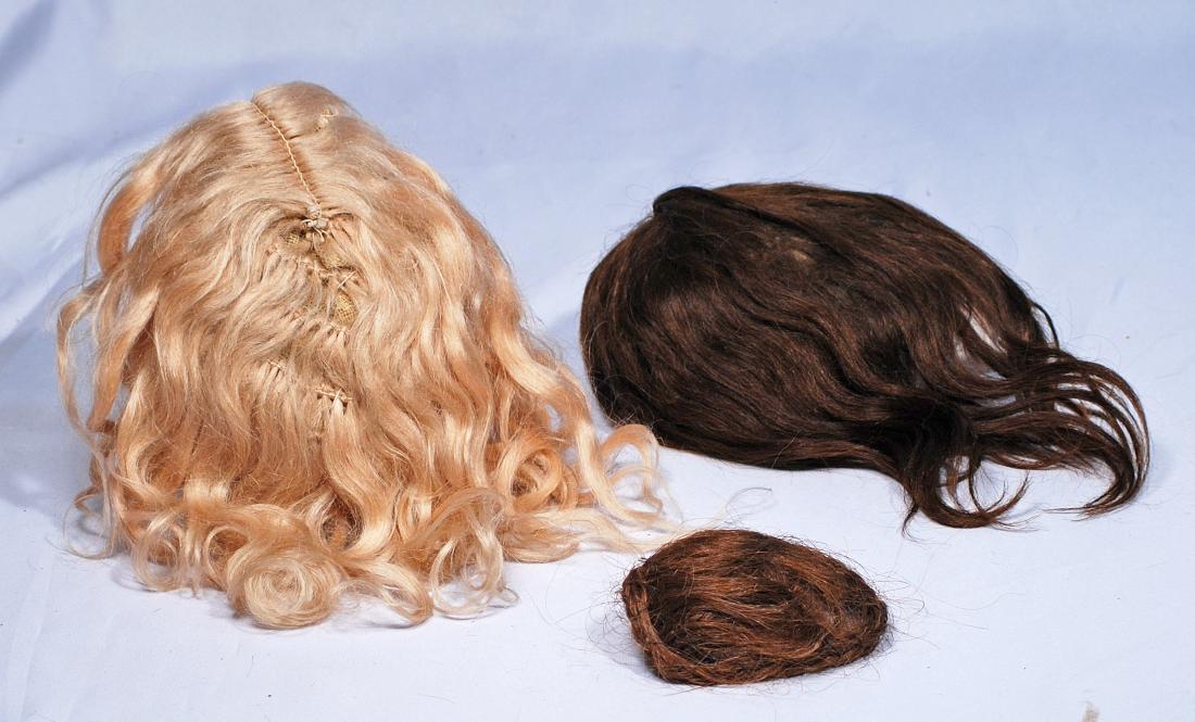 263.  THREE ANTIQUE DOLL WIGS.  Blonde mohair with (1 of 1)