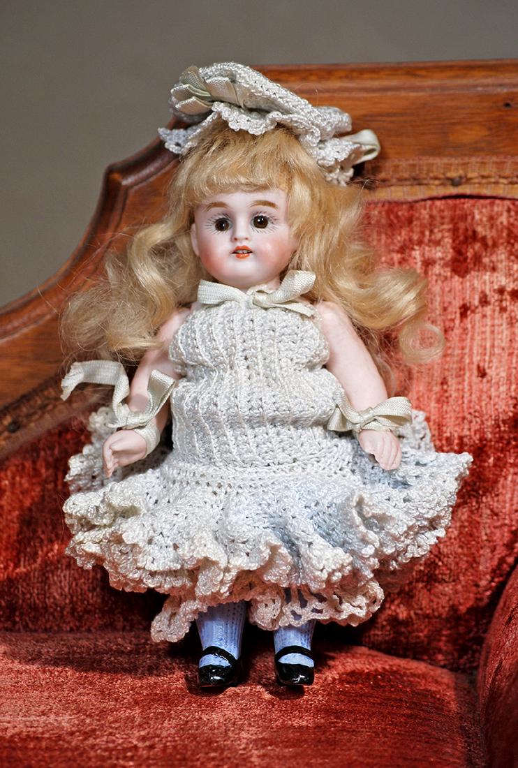 GERMAN ALL-BISQUE DOLL BY KESTNER. Marks: 150 6 ¼".: GERMAN ALL-BISQUE DOLL BY KESTNER. Marks: 150 6 ¼". Jointed shoulders and hips, brown sleep eyes, painted lashes, feathered brows, open mouth, accented lips, upper teeth, original long blonde mohair