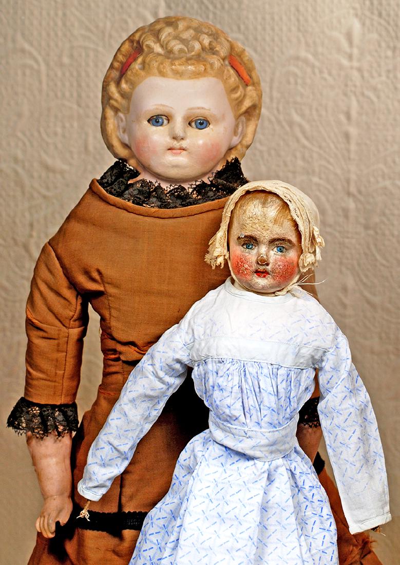 GERMAN WAX-OVER-PAPER MACHE DOLL WITH SLEEP EYES. 26".: GERMAN WAX-OVER-PAPER MACHE DOLL WITH SLEEP EYES. 26". Shoulderhead doll with rounded face, blue sleep eyes, tapered brows, closed mouth, blushed rosy cheeks, molded hair in ornate curly arrangement w