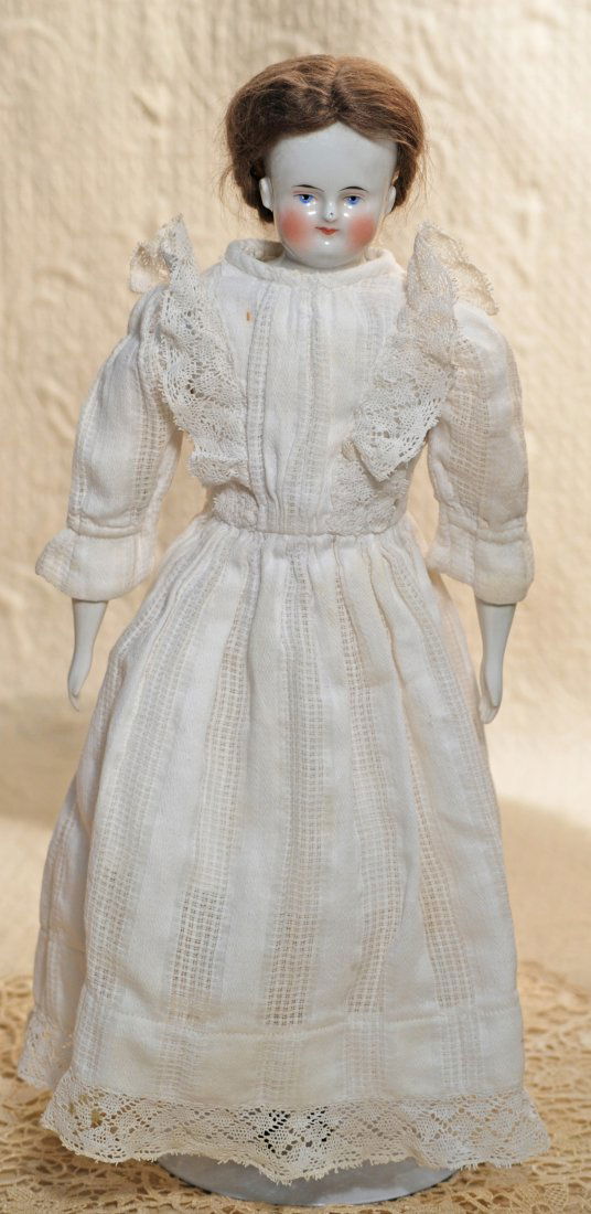 GERMAN BEIDERMEIER CHINA LADY.: GERMAN BEIDERMEIER CHINA LADY. 16”. China shoulderhead with painted black pate, brown mohair wig, painted features, blue eyes, red and black lid lines, closed mouth, accented lips, replacement cloth