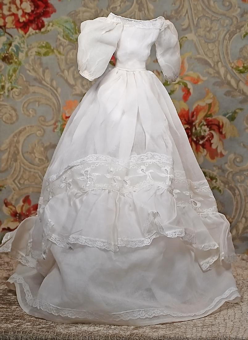 WHITE ORGANDY DOLL GOWN. White organdy made up in gown: WHITE ORGANDY DOLL GOWN. White organdy made up in gown with fitted bodice, rounded neckline with lace trim, narrow waist, poufed sleeves, long billowy full skirt with lace trim and accents, back snap