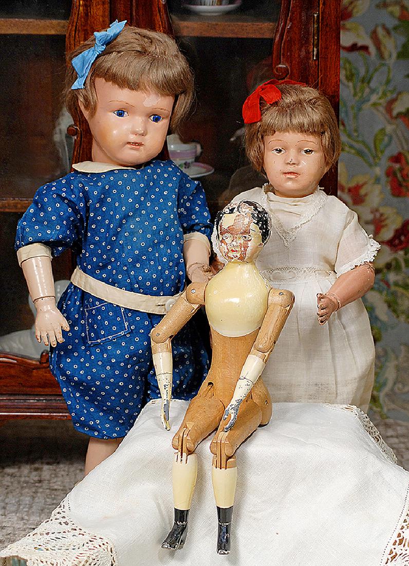 TWO SCHOENHUT CARVED WOODEN DOLLS: CHARACTER GIRL 308: TWO SCHOENHUT CARVED WOODEN DOLLS: CHARACTER GIRL 308 AND "MISS DOLLY" Marks: Incised Schoenhut mark 17" Miss Dolly; 14 1/2" character Each has carved wooden socket head on spring-jointed wooden body,