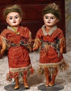 TWO GERMAN BISQUE NATIVE AMERICAN DOLLS.: TWO GERMAN BISQUE NATIVE AMERICAN DOLLS. Marks: 7/0. 9 ½”. Each has sienna tinted bisque socket head, dark glass stationary eyes, painted lashes, wavy brows, open mouth, mohair wig, crude five-piec