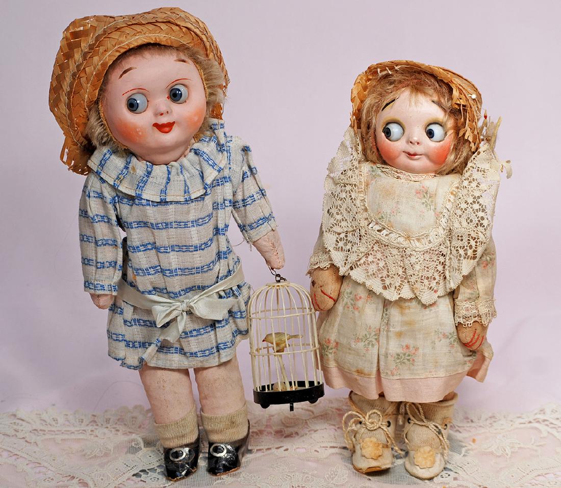 154. ALL-ORIGINAL GERMAN MASK-FACED GOOGLY. 10".: 154. ALL-ORIGINAL GERMAN MASK-FACED GOOGLY. 10". Composition mask-face with large blue glass side-glancing eyes, high arched brows, closed mouth, tiny nose, mohair wig, pink cotton body with jointing