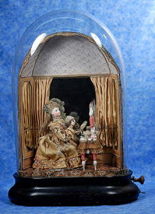 82. FRENCH AUTOMATON “LADY PREPARING FOR A: 82. FRENCH AUTOMATON “LADY PREPARING FOR A BALL” BY PHALIBOIS. 30” (Including dome). A bisque head lady has blue glass eyes, painted lashes and brows, closed mouth, accented lips,