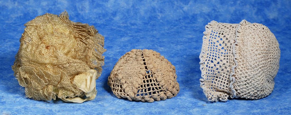 128. SIX DOLL BONNETS. Includes: Cream all-lace bonnet (1 of 2)
