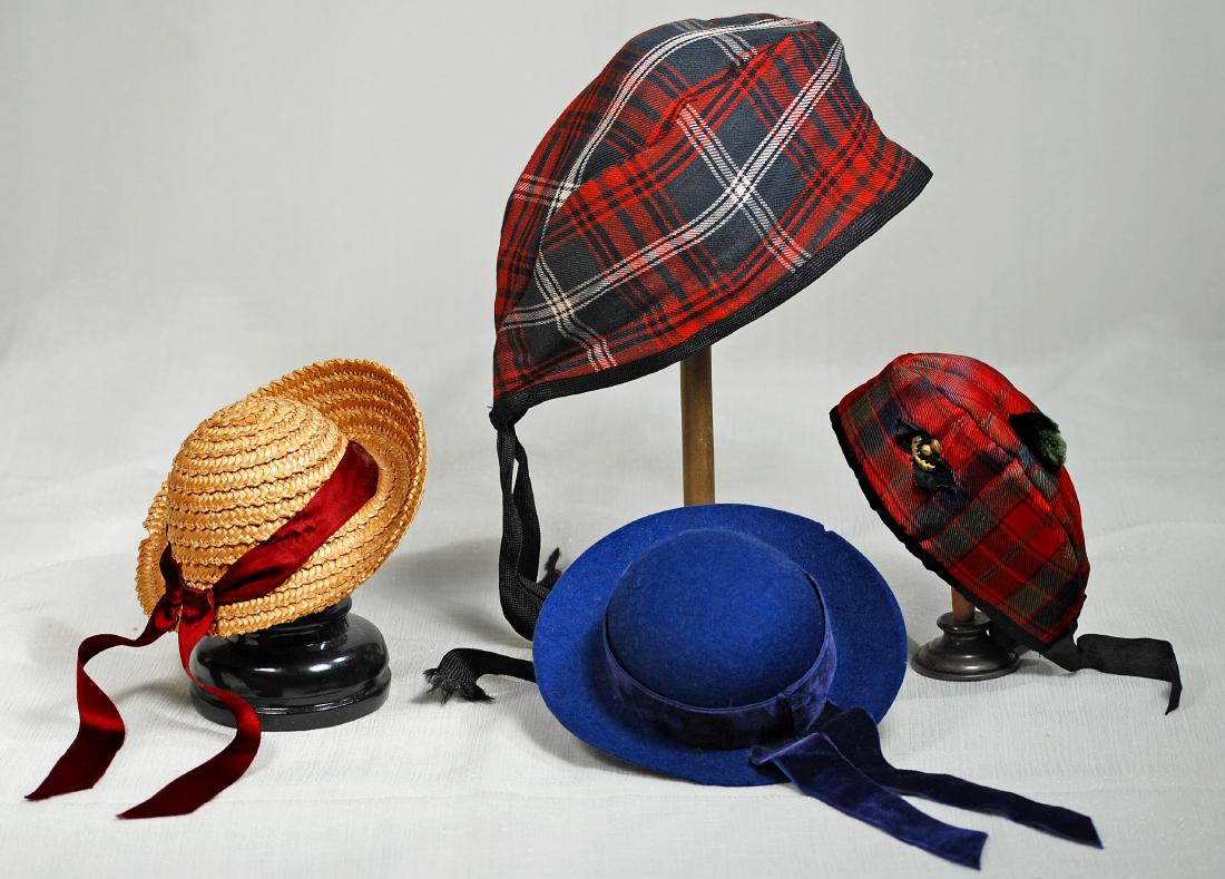 103. FOUR DOLL BONNETS. Includes: Woven straw bonnet (1 of 1)