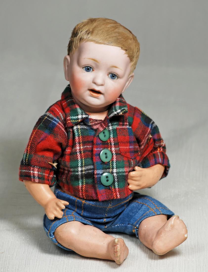 132. GERMN BISQUE KESTNER BABY. Marks: made in Germany: 132. GERMN BISQUE KESTNER BABY. Marks: made in Germany 211 JDK. 10”. Bisque socket head, blue sleep eyes, painted lashes, feathered brows, open mouth, two lower teeth, original lamb-skin wig, co
