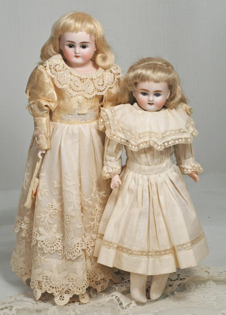 145. TWO GERMAN BISQUE DOLLS BY ALT, BECK &: 145. TWO GERMAN BISQUE DOLLS BY ALT, BECK & GOTTSCHALCK. 15” and 13”. Each has bisque shoulderhead, set glass eyes, painted lashes, feathered brows, open mouth, upper teeth, kid body with