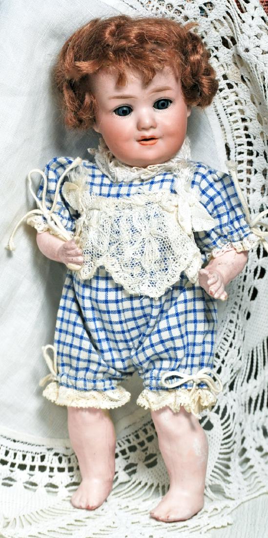 195. ARMAND MARSEILLE, 560, BISQUE CHARACTER WITH: 195. ARMAND MARSEILLE, 560, BISQUE CHARACTER WITH TODDLER BODY. Marks: Made in Germany, Armand Marseille, 560, A 8 / 0 M. DRGM. 9”. Bisque socket head, blue sleep eyes, painted lashes, feathered