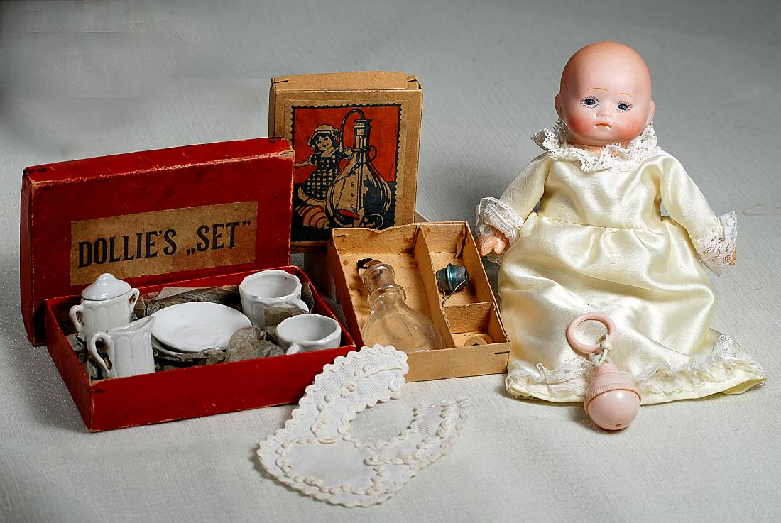 196. TINY GERMAN BISQUE INFANT & MINIATURE TEA SET & (1 of 1)