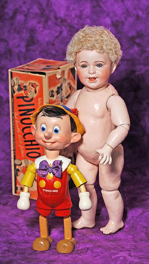 125-A. COMPOSITION “PINOCCHIO” BY IDEAL: 125-A. COMPOSITION “PINOCCHIO” BY IDEAL WITH ORIGINAL BOX. Marks: Pinocchio Des. & c. by Walt Disney, Made by Ideal Novelty & Toy. 11”. Composition socket head with distinct characte