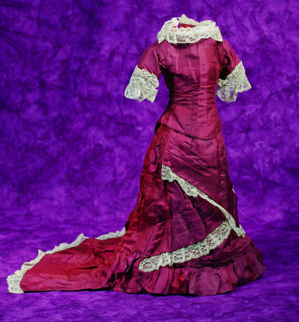 136. BEAUTIFUL ANTIQUE MAROON SILK SATIN FASHION GOWN.: 136. BEAUTIFUL ANTIQUE MAROON SILK SATIN FASHION GOWN. Two piece gown features a fitted bodice with rounded neckline, poufed sleeves, lace edging at neckline and sleeves, V-shaped front with back clos