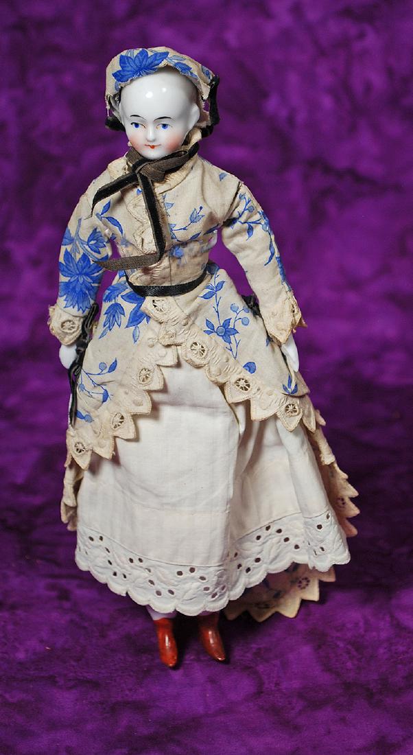 152. GERMAN DOLLHOUSE CHINA KNOWN AS BEIDERMEIER. 8: 152. GERMAN DOLLHOUSE CHINA KNOWN AS BEIDERMEIER. 8 ½”. Porcelain shoulderhead with solid-dome and painted black pate, painted features, blue eyes, black and red lid lines, tapered brows, c