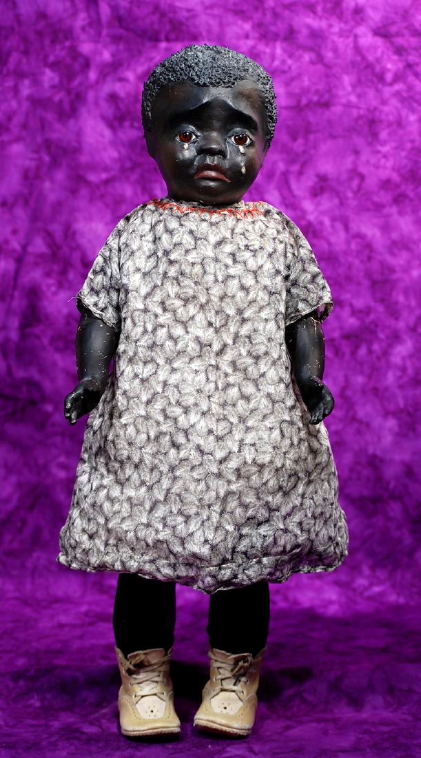 160. RARE TEARY-EYED BLACK PAPER MACHE PORTRAIT DOLL BY: 160. RARE TEARY-EYED BLACK PAPER MACHE PORTRAIT DOLL BY LEO MOSS. Marks: L.M. (incised back of head), Leotta, two years old, 1929 (hand lettered cloth label sewn on front torso). 23". Paper mache swiv