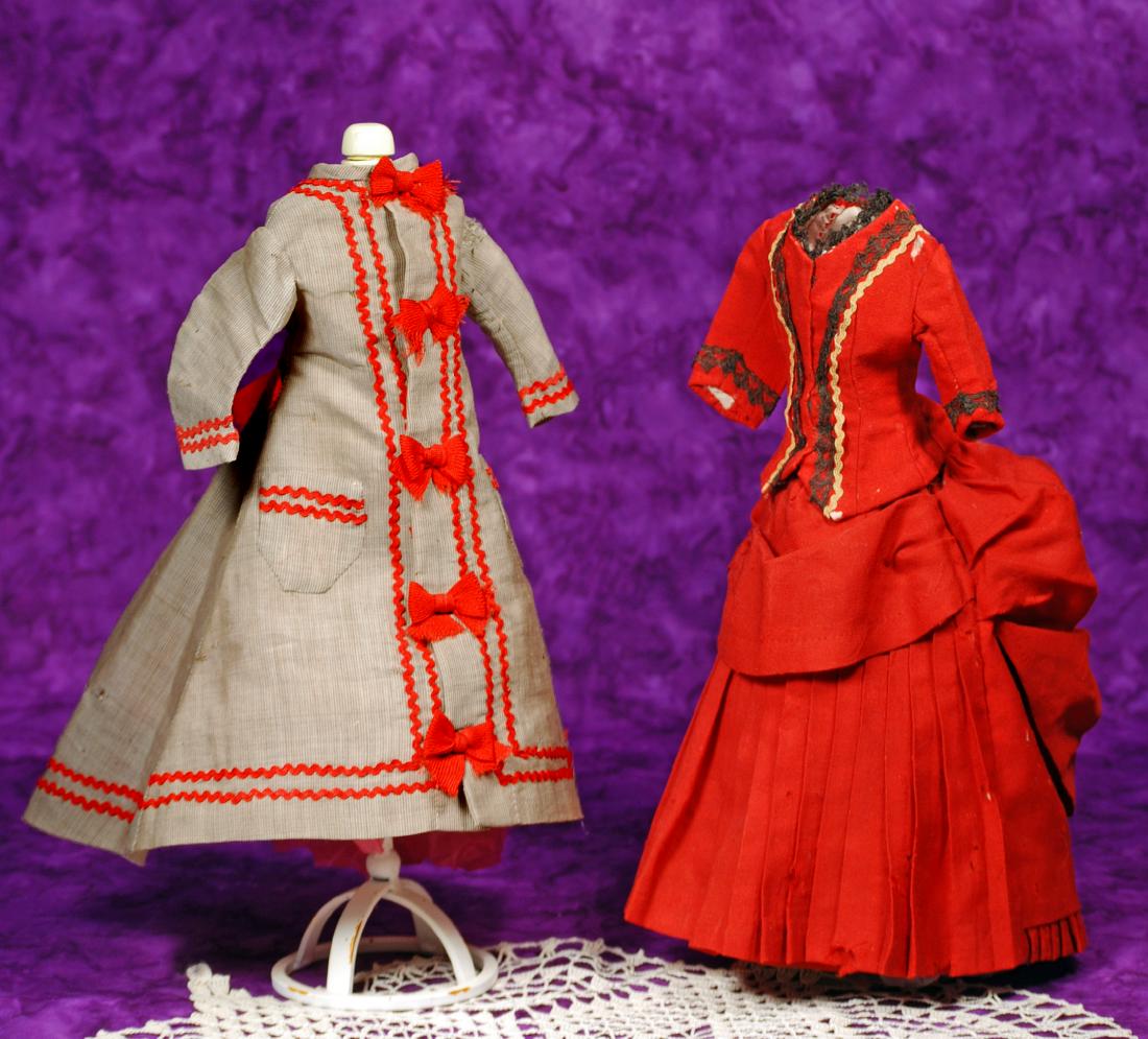 222. TWO ANTIQUE FASHION GOWNS. (1) Tan wool and silk: 222. TWO ANTIQUE FASHION GOWNS. (1) Tan wool and silk princess-style gown, dart-shaped back with full train, long sleeves, two pockets, all trimmed in bands of red rick-rack, front accented with red b