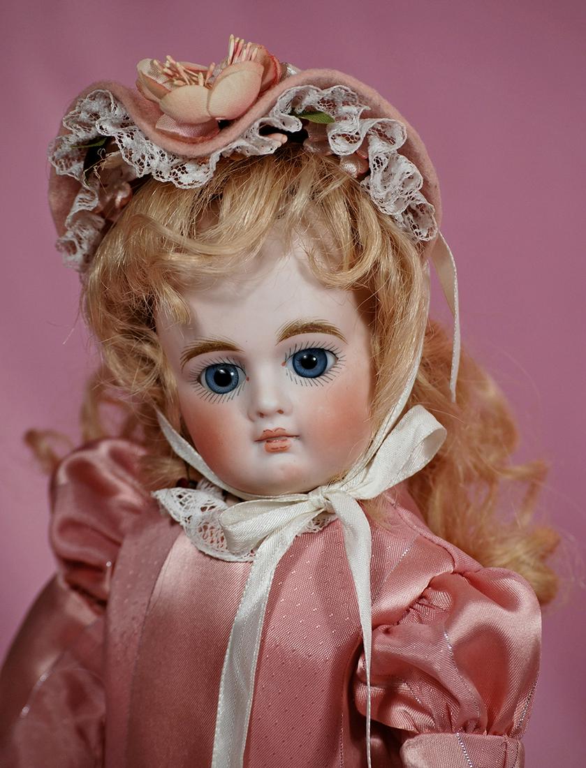 32. SONNEBERG BISQUE CLOSED-MOUTH DOLL FOR THE FRENCH: 32. SONNEBERG BISQUE CLOSED-MOUTH DOLL FOR THE FRENCH MARKET. 14.5”. Bisque socket head, stationary blue glass eyes, painted lashes, feathered and brushstroked brows, pierced ears, closed mouth with