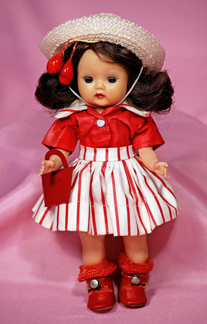 161. “MUFFIE IN DRESS-UP STYLE #704, BY NANCY ANN: 161. “MUFFIE IN DRESS-UP STYLE #704, BY NANCY ANN STORYBOOK DOLLS. 8”. Hard plastic walker, dark sleep eyes, painted curly upper lashes and molded upper lashes, brunette side-part wig, wears red a
