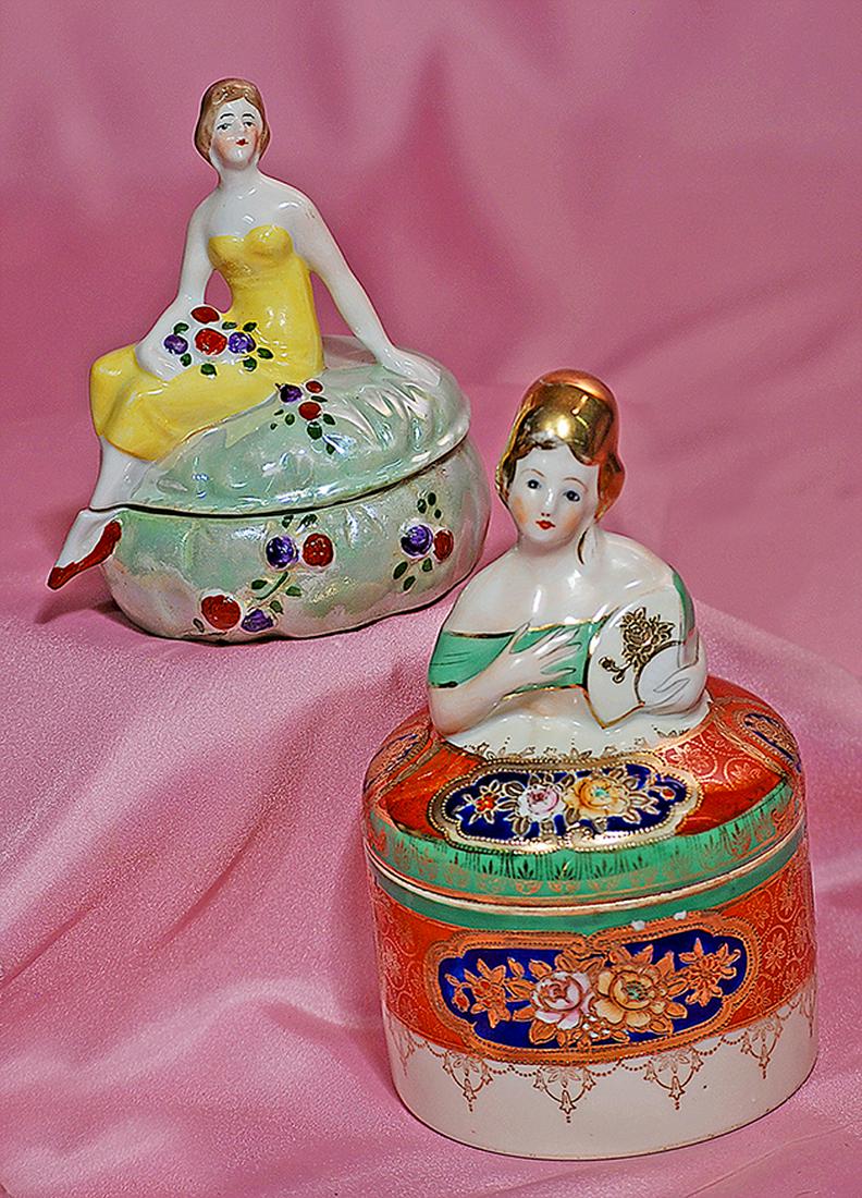 181. NORITAKE PORCELAIN FIGURAL POWDER JAR. Marks:: 181. NORITAKE PORCELAIN FIGURAL POWDER JAR. Marks: Noritake. 6”. Porcelain powder jar with intricate floral and lattice design embellished with brilliant gilt touches; features a lady holding a fan,