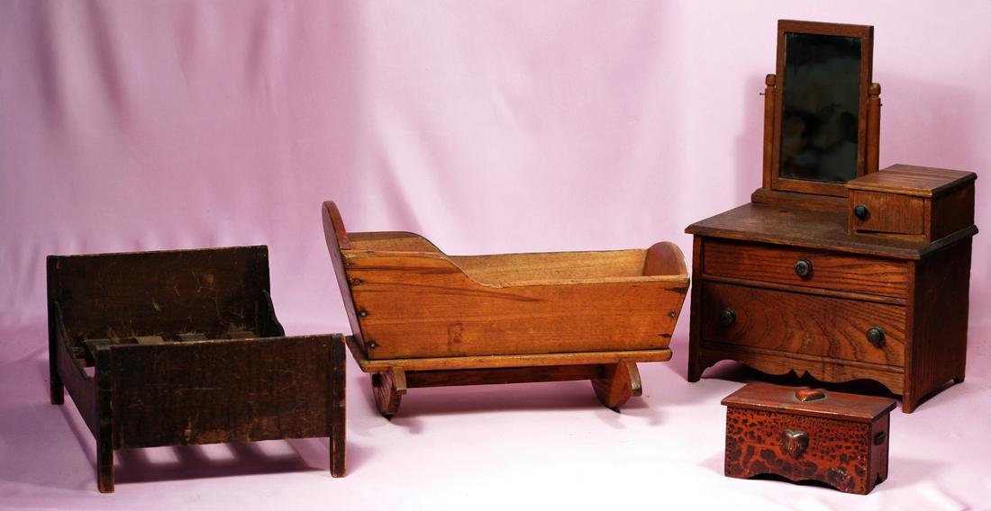 248-B. GROUP OF SMALL DOLL-SIZE FURNISHINGS.: 248-B. GROUP OF SMALL DOLL-SIZE FURNISHINGS. Includes: 14.5” wooden dresser; 13” x 9” wooden bed with slats; 13.5” L. pine wood cradle; wooden chest with hinged lid and carved wooden hearts, i