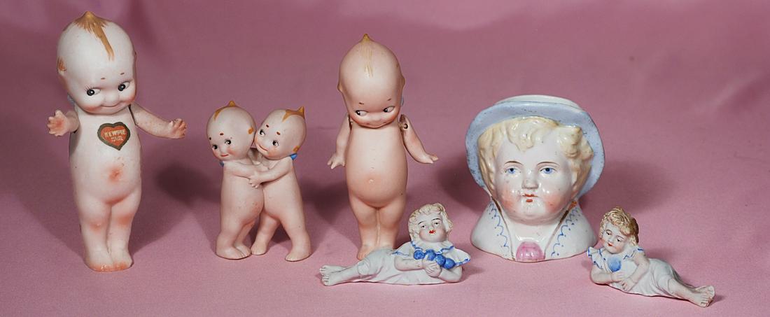 260. GERMAN BISQUE KEWPIES, PAIR PIANO BABIES & HEAD: 260. GERMAN BISQUE KEWPIES, PAIR PIANO BABIES & HEAD VASE. 4” Nippon standing Kewpie with chest label, 5” standing bisque Kewpie, 3.5” pair Kewpie huggers; pair of 3.25” bisque figures with bl