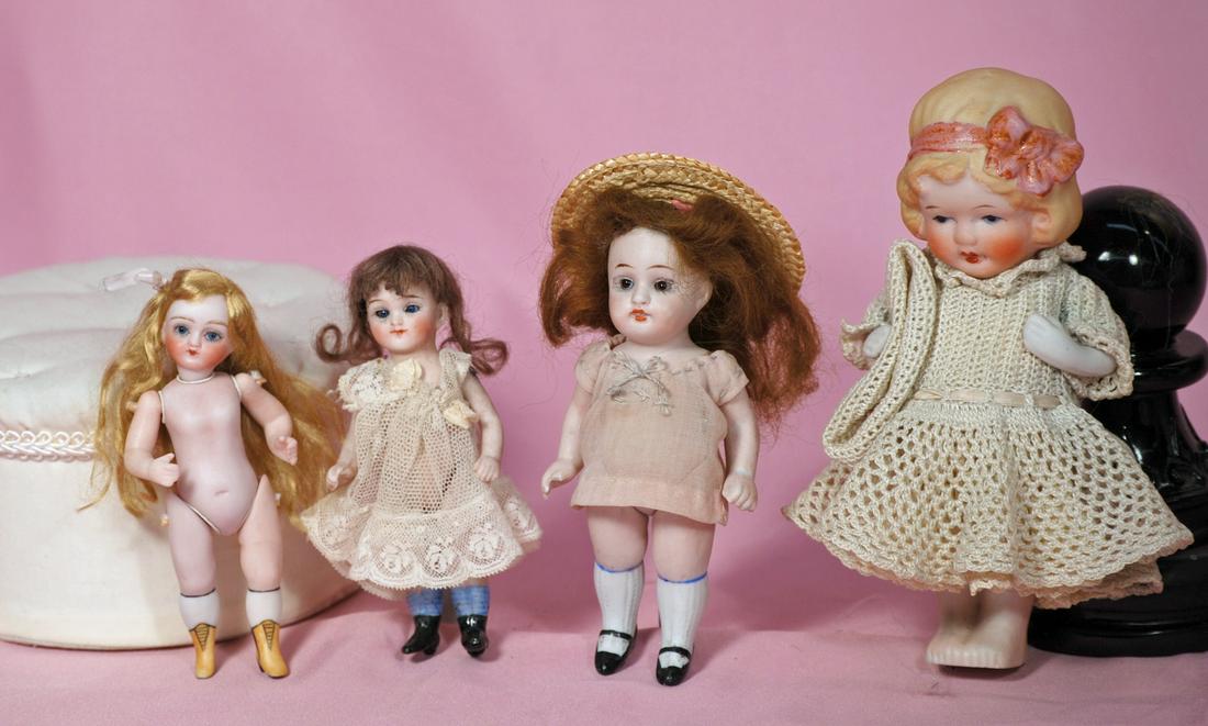 261. FOUR ALL-BISQUE DOLLS. 5.5” Kestner 150,: 261. FOUR ALL-BISQUE DOLLS. 5.5” Kestner 150, stationary glass eyes, jointed shoulders and hips, wig, pink silk dress (scratch on left leg) ; 4.5” doll marked 5201, stationary glass eyes, closed m