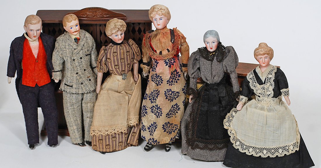 FAMILY OF SIX DOLLHOUSE DOLLS 6" to 61/4" Each has: FAMILY OF SIX DOLLHOUSE DOLLS 6" to 61/4" Each has bisque shoulderhead with sculpted hair and painted facial features, muslin body, bisque lower limbs, painted shoes or boots Includes: Two ladies with