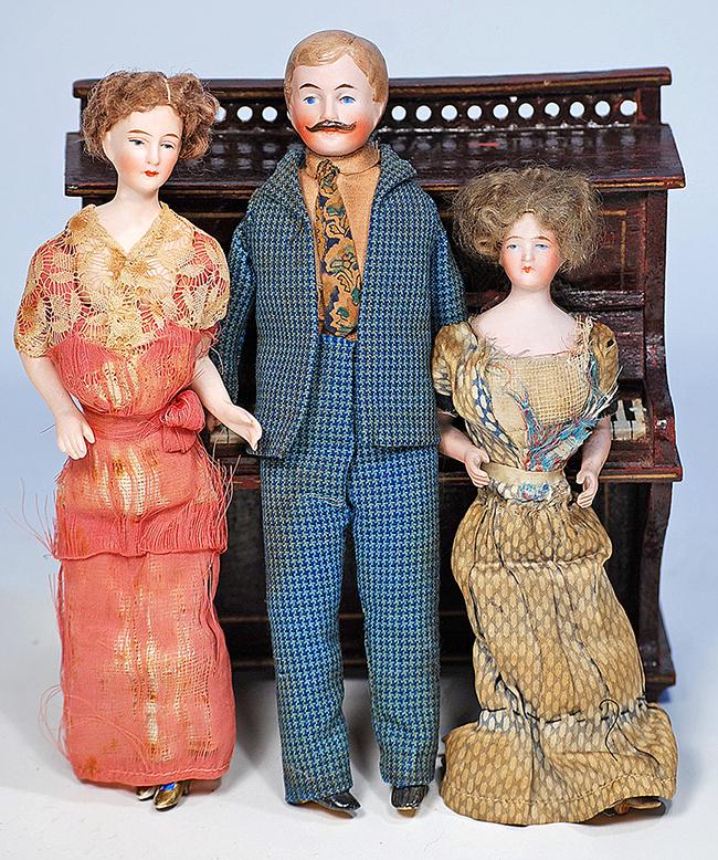 THREE DOLLHOUSE DOLLS IN ORIGINAL COSTUME 6" to 8": THREE DOLLHOUSE DOLLS IN ORIGINAL COSTUME 6" to 8" Each has bisque shoulderhead with painted features, muslin body with bisque arms and lower legs, painted shoes or boots, original costumes; two ladie