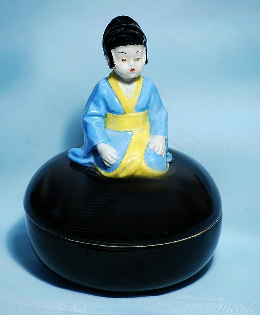 GERMAN PORCELAIN POWDER BOX FEATURING ASIAN CHILD: GERMAN PORCELAIN POWDER BOX FEATURING ASIAN CHILD Marks: 33 (inside lid) 7" Porcelain powder box has ebony black finish and features a young Asian child in kneeling pose; welldefined back hair, downwa