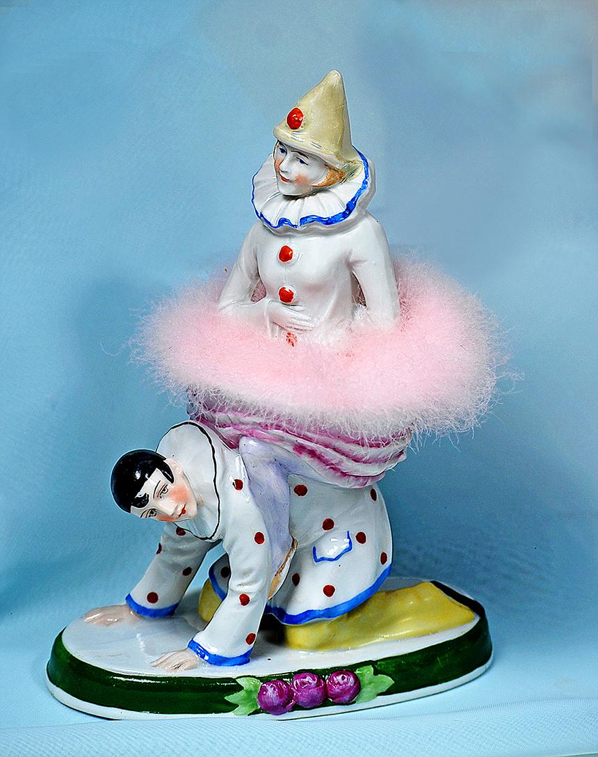 SITZENDORF PORCELAIN HALF DOLL PIERETTE ON PIERROT: SITZENDORF PORCELAIN HALF DOLL PIERETTE ON PIERROT POWER PUFF DISH Marks: 26002, crown over S mark 8" H x 5 1/2" W (on base) Pierette half doll with hands to side has a pink powder puff skirt and is r